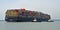 The container ship Maersk Edirne being turned by tug boats at the port of Felixstowe.