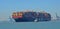 The container ship Maersk Edirne being turned by tug boats at the port of Felixstowe.