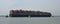 The container ship Maersk Edirne being turned by tug boats at the port of Felixstowe.