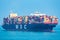 Container ship `MSC Josseline` sailing through calm blue ocean.