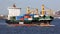 Container ship SPICA underway in New York Harbor, close up, Brooklyn and Governors Island in the background