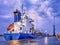 Container ship at twilight with dramatic clouds, Port of Antwerp, Belgium.