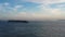 Container ships pass in and out Victoria Harbour at dusk