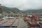 Container terminal in the Port of La Guaira observed from cargo ship moored below gantry cranes.