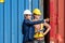 Container yard manager talking to female foreman about the goods inside the warehouse while shipping