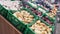 Containers with Onions, Garlic, and Cabbage with Price Tags on Supermarket Shelf