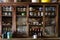 Containers such as zinc cups, bowls and bottles of beer in wooden cabinet in grocery store at Thangu and Chopta valley in winter.