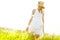 Contemplating natures beauty. A beautiful young blonde woman standing in a meadow wearing a sunhat on a warm summers day