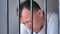 Contemplation Behind Prison Bars: Man in Deep Emotional Turmoil
