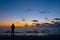 Contemplation at Dusk: Solitary Figure by the Sea