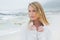 Contemplative casual young woman at beach