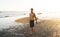 Contemplative Caucasian guy holding professional surfboard waiting for waves at Philippines island