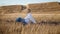 Contemplative girl sitting field alone. Blonde woman putting spikelet hairstyle