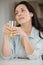 contemplative woman holding glass juice