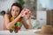 contemplative woman holding globe and piggy bank