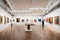 A contemporary art gallery featuring track lighting, white gallery walls,