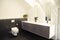 Contemporary attic bathroom with toilet bowl, marble floor, faucets