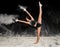 Contemporary ballet dancer dancing on the stage with flour