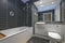 Contemporary bathroom with black tiles