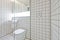 Contemporary bathroom with retro white tiled walls