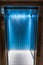 Contemporary blue elevator interior with metal doors
