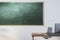 Contemporary classroom interior with empty mock up chalkboard, wooden furniture, daylight and equipment. Education, knowledge and