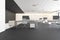 Contemporary concrete coworking office interior with furniture, devices and daylight. Corporate workplace concept.