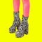 Contemporary digital collage art. Boots Zebra shoes unrecognizable feet in isometry. Fashion Animal print party concept