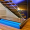 A contemporary floating staircase with LED-lit steps and glass balustrades5, Generative AI