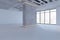 Contemporary gallery warehouse interior with mock up place on concrete walls and panoramic windows with city view.