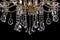Contemporary gold chandelier isolated on black background. close-up . Crystal chandelier