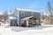 Contemporary gray two-story residential house with a wood-covered patio in the foreground