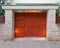 Contemporary house main entrance with natural wood door and stone fence