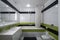 Contemporary interior of bathroom in modern flat. Black and green tile. Sink and mirror. Bath with shower.