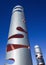 Contemporary metal cylindrical sculpture against a blue sky