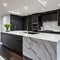 A contemporary, monochromatic kitchen with sleek stainless steel appliances and a marble waterfall island2, Generative AI
