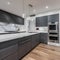 A contemporary, monochromatic kitchen with sleek stainless steel appliances and a marble waterfall island4, Generative AI