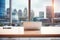 Contemporary office setup with a laptop on a blurred cityscape background