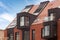 Contemporary Residential Building Exterior in the Daylight with modern balcony and brick facade.