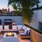 A contemporary rooftop terrace with outdoor seating, a fire pit, and stunning city views3, Generative AI