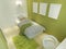 Contemporary room for a teenager with a big bed and mockup posters on the green wall.