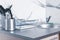 Contemporary shiny modern kitchen interior with a metal sink and kitchenware and accessories
