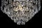 Contemporary silver chandelier isolated on black background. Crystal chandelier close-up.