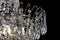 Contemporary silver chandelier isolated on black background. Crystal chandelier close-up.