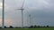 Contemporary windmills row generate energy with blades