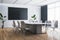 Contemporary wooden and concrete meeting room interior with window and city view, furniture and black mock up screen.