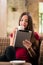 Contemporary young woman reading on tablet in a coffee shop