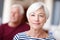 Content in her senior years. Portrait of a senior woman with her husband in the background.