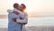 Content young African couple embracing each other at the beach