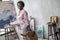 Contented african woman in pink clothes in the art studio